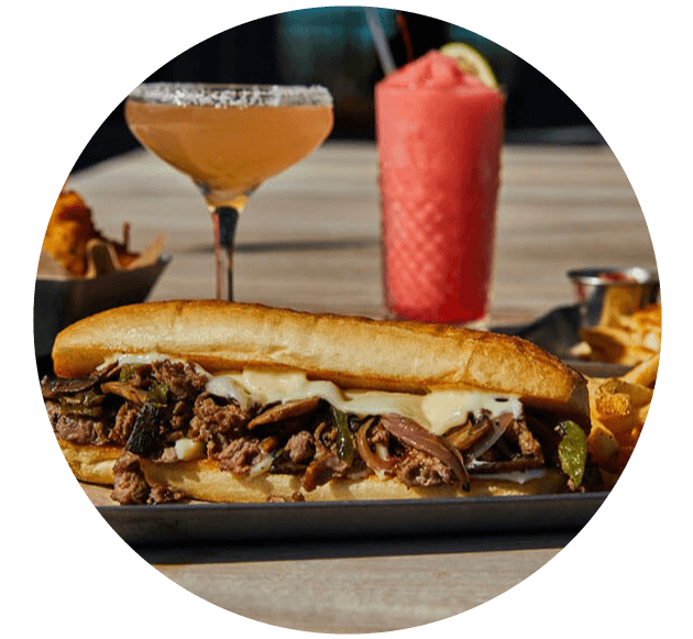 A sandwich and a drink placed on a table, ready to be enjoyed.